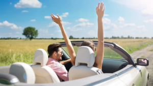 Couple driving in a convertible enjoying a sunny road trip on a budget.