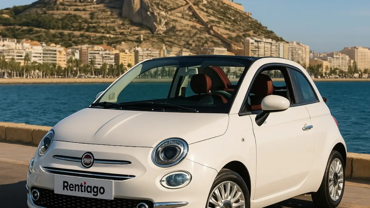 City car driving along Benidorm coastline with sea and city skyline – ideal urban vehicle for Costa Blanca.