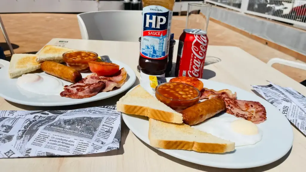 Traditional full English breakfast with eggs, bacon, sausages, baked beans and toast served at a café near Levante Beach in Benidorm