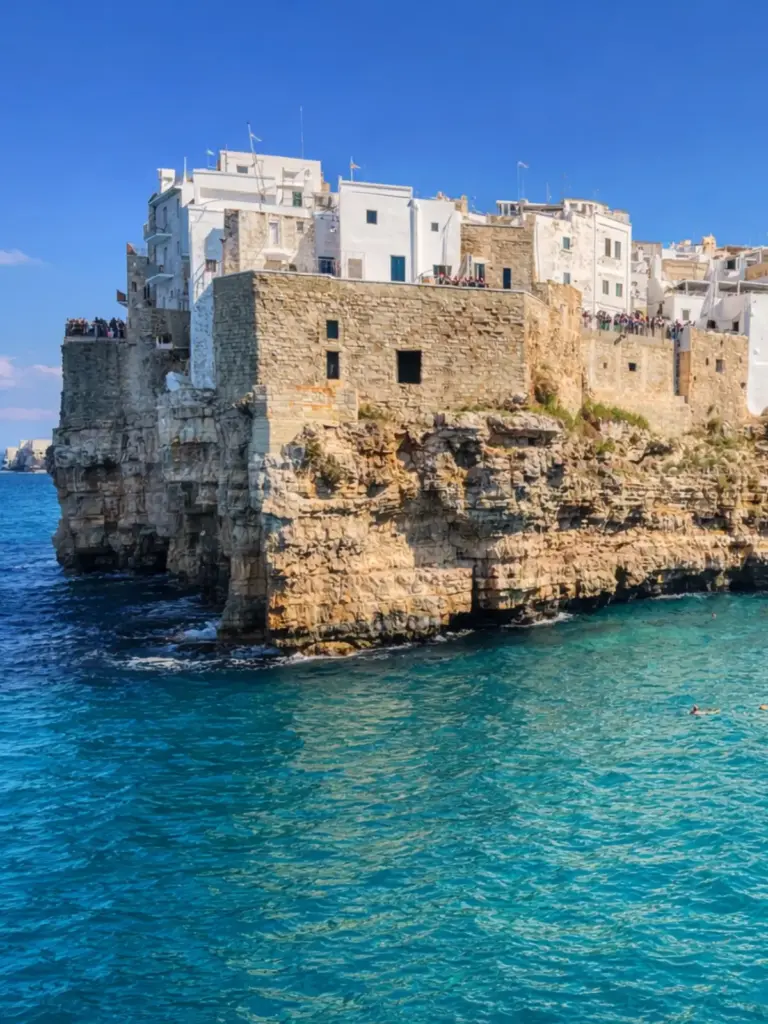 Colorful Italian cliffside village at sunset overlooking the Mediterranean Sea